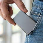 Hand holding the SSD to show scale